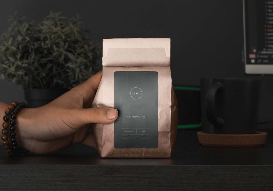 Free Hand Holding Coffee Packaging Mockup